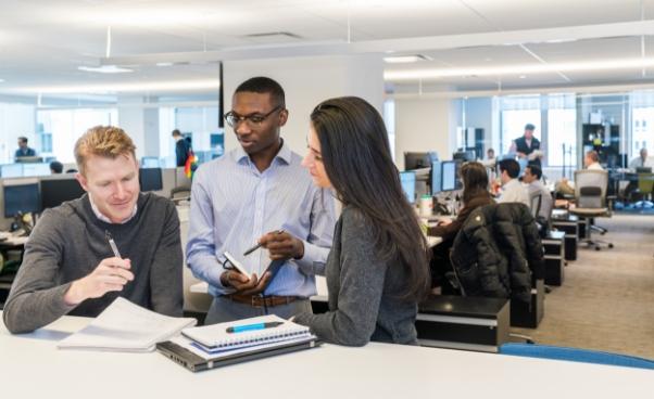 Ares Management employees collaborating at a desk