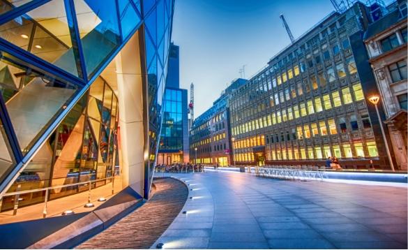 View from the street of a office building and other large buildings View from the street of a office building and other large buildings